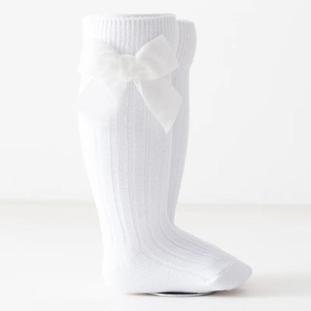 Cute Christmas knee-high socks for girls. Soft cotton blend with red bow, perfect for winter outfits, comfort, and festive holiday style.