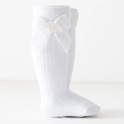 Cute Christmas knee-high socks for girls. Soft cotton blend with red bow, perfect for winter outfits, comfort, and festive holiday style.