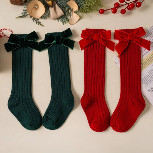 Cute Christmas knee-high socks for girls. Soft cotton blend with red bow, perfect for winter outfits, comfort, and festive holiday style.