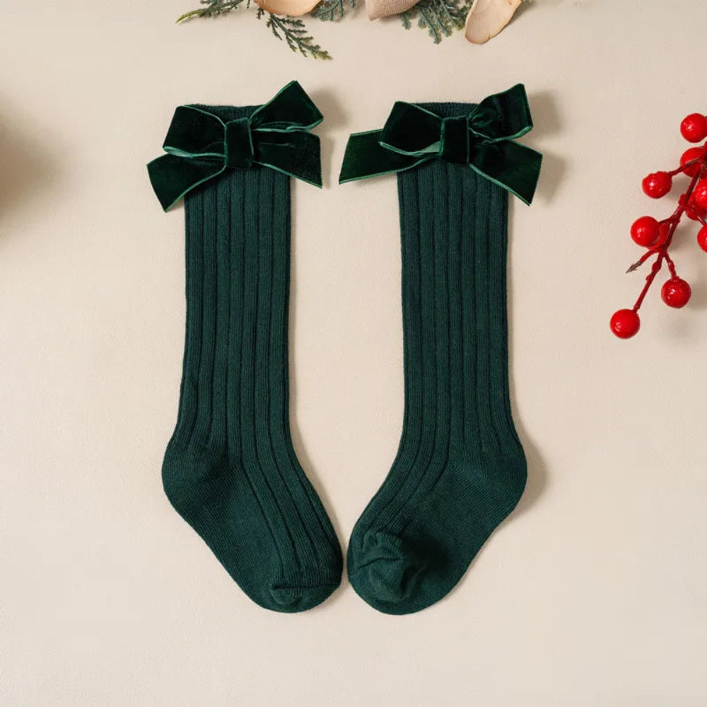 Cute Christmas knee-high socks for girls. Soft cotton blend with red bow, perfect for winter outfits, comfort, and festive holiday style.