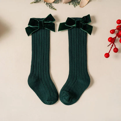 Cute Christmas knee-high socks for girls. Soft cotton blend with red bow, perfect for winter outfits, comfort, and festive holiday style.
