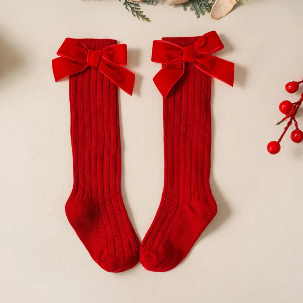 Cute Christmas knee-high socks for girls. Soft cotton blend with red bow, perfect for winter outfits, comfort, and festive holiday style.